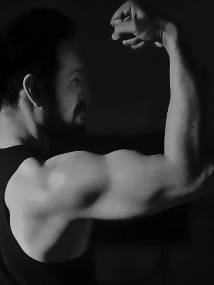 This artistic shot highlights the bicep peak. Building impressive arms is a common goal, and I provide the techniques to develop both size and shape.