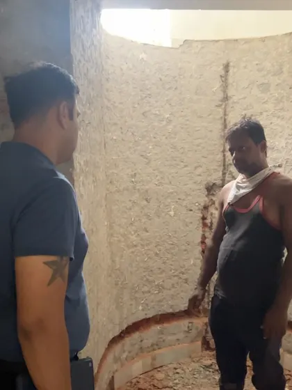 Inspecting the initial civil work for a curved shower area. Getting the structure right at this stage is critical for a flawless finish in the bathroom.