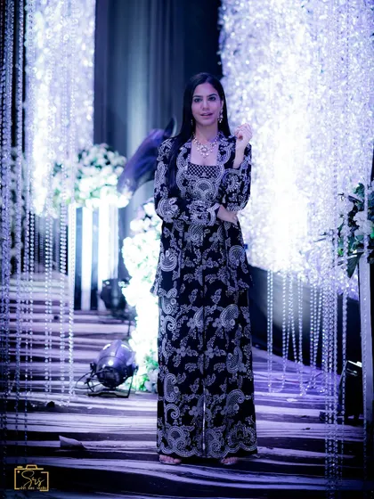 A full-length shot of the co-ord set against a glamorous, lit-up backdrop.