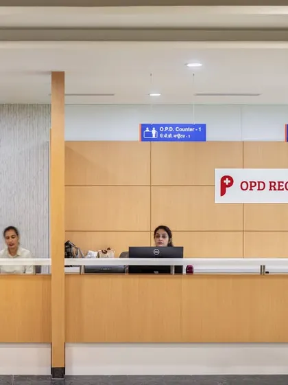 The OPD registration desk at Pragma Medical Institute is designed for efficiency and clarity. The open-plan counter and clear signage help streamline the check-in process, while the warm wood finishes provide a welcoming touch.