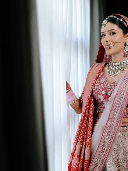 A classic bridal portrait by a window, using natural light to create a soft and flattering image.