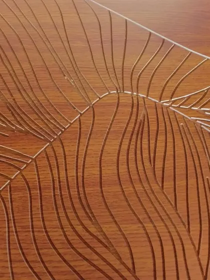 A close-up of the finely carved lines that form the rolling hills and mountains. The texture adds a beautiful, tactile quality to the artwork.
