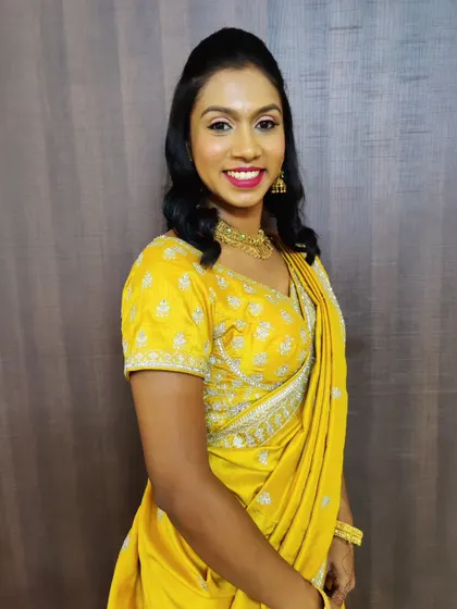 A bright and sunny look for a party. The yellow lehenga is complemented by fresh, glowing makeup and a cheerful red lip.