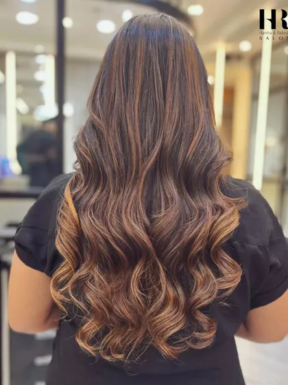 A classic example of a brunette balayage, with caramel ribbons adding richness and movement to the hair.