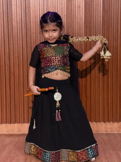 This student showcases her beautiful multi-colored choli and traditional jewelry. We celebrate the rich details of Indian culture through costume and dance.