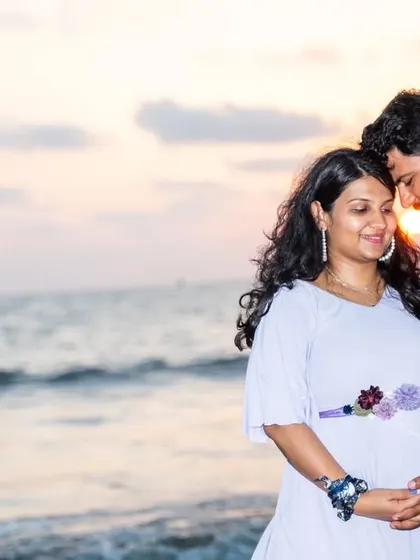 A golden hour silhouette on the beach. This intimate portrait captures the couple's connection as the sun sets over the water, creating a warm, romantic, and unforgettable maternity photo.