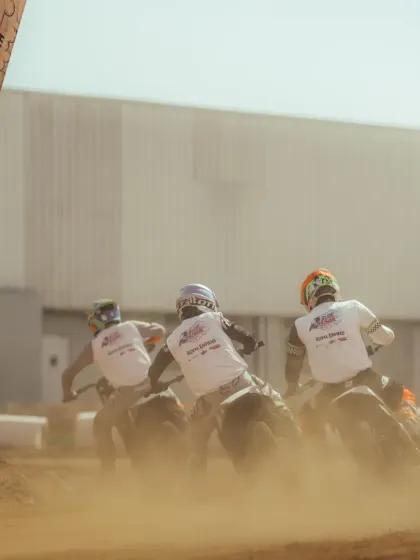 The start of a flat track race is an explosion of dirt and power. Here you can see the riders launching off the line, fighting for the best position heading into the first corner.