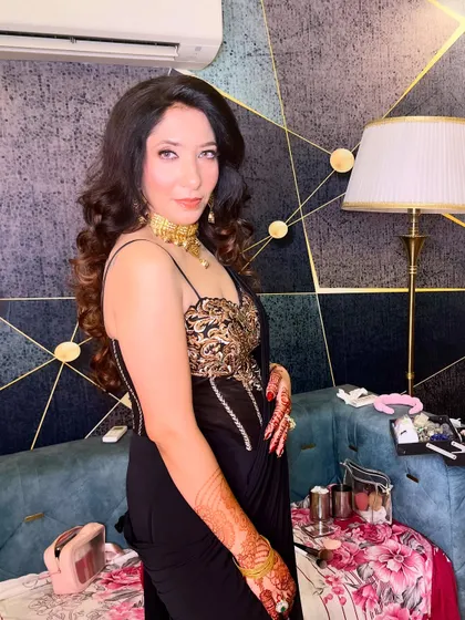 Another angle of this stunning party look, showcasing the beautiful details of the outfit and the flawless makeup.