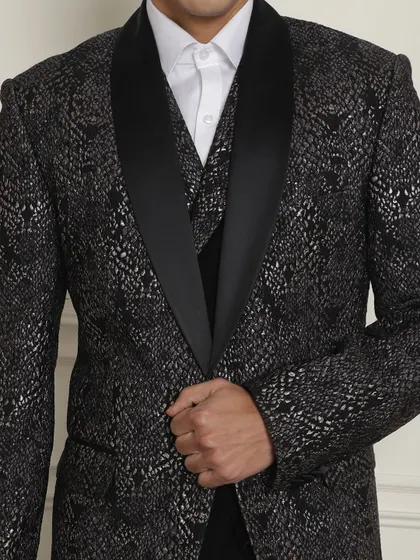 A close-up of a black and silver patterned tuxedo jacket, a great option for summer occasions that call for pleasing prints.