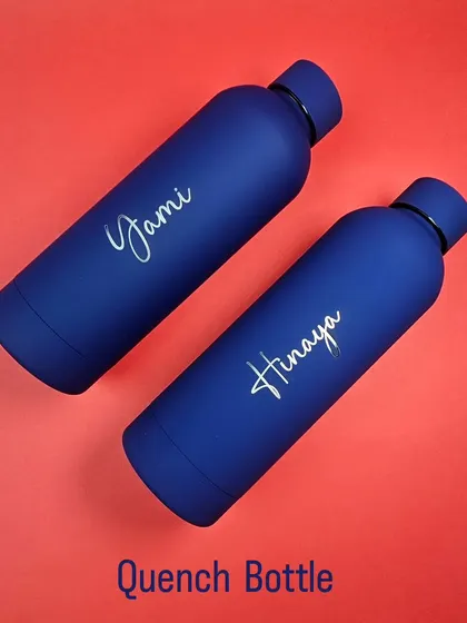 The Quench Bottle features a stylish matte finish and can be personalized with a name in a beautiful script font. It's designed to be both functional and fashionable.