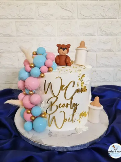 "We can bearly wait" is such a popular baby shower theme. This design features a cascade of pink and blue chocolate spheres, a fondant teddy, and milk bottles.