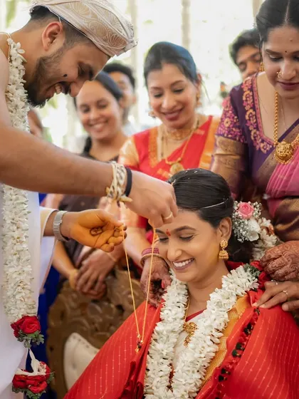 The tying of the Mangalyam is a pivotal moment. I captured the groom's gentle focus and the bride's happy smile, a beautiful exchange that marks the beginning of their marriage.
