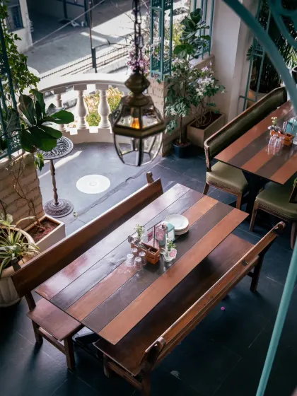 Sunlight finds its way into every corner. This view shows one of our semi-private spaces, perfect for a sunlit brunch, an intimate gathering, or a quiet moment away from the crowd.