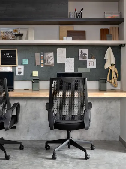 A closer look at one of the workstations. The large pin-up board is essential for our creative process, allowing us to display mood boards, material samples, and sketches, keeping inspiration within arm's reach.
