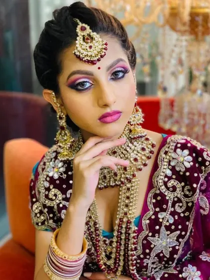 A close-up of the North Indian bridal makeup, showing the sharp, defined eyes and the perfectly coordinated lip color.