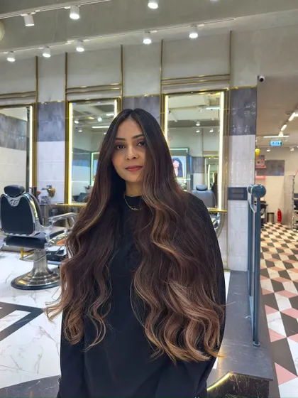 A front view of a bold and brilliant balayage. The color is concentrated towards the ends, creating a modern ombre effect with soft, blended transitions.