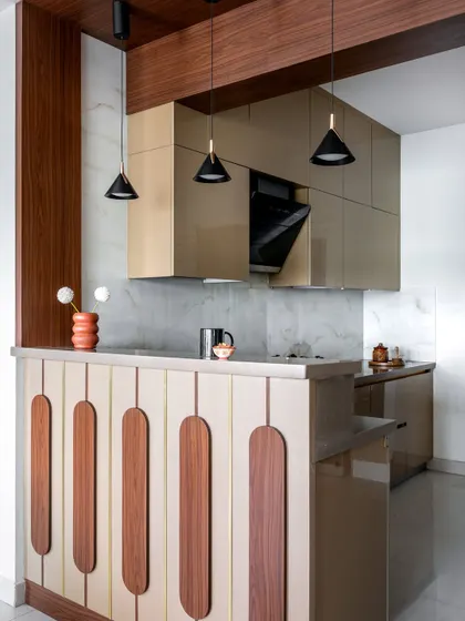 This angle shows the breakfast bar and pendant lighting, which help define the kitchen space. The design balances privacy with connectivity to the main living area.