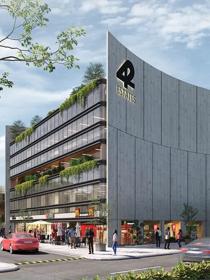 A render for the '42 Estates' commercial project, featuring a distinctive curved concrete wall that acts as a landmark. The design integrates retail at the ground level with green terraces on upper floors, creating a vibrant, mixed-use destination.