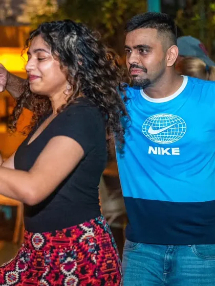 A focused and stylish pair. The patterned skirt and Nike shirt show off their individual styles.
