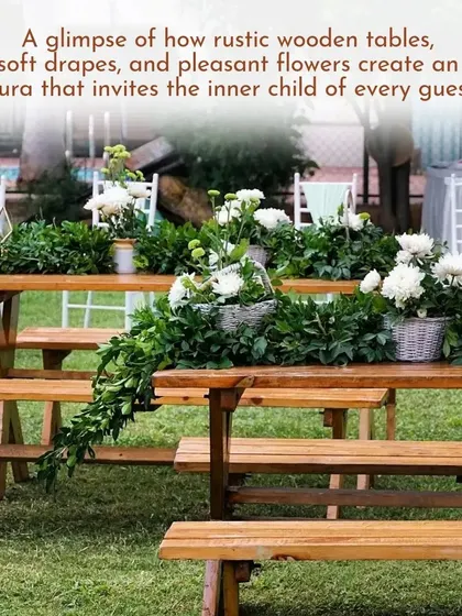 For a relaxed, countryside vibe, we used rustic wooden picnic tables and benches, decorated with simple runners of fresh greenery. This setup creates an informal and inviting space for guests to connect.
