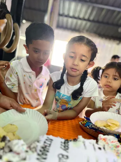 Friends waiting for cake together. These shared moments of anticipation and fun build strong bonds.