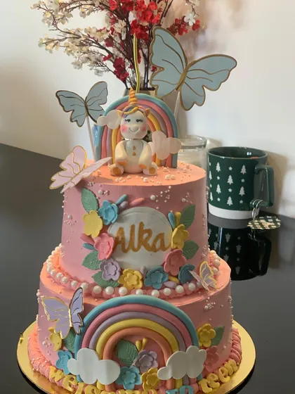 Another beautiful two-tier unicorn and rainbow cake. This one combines a fondant unicorn, rainbows, and butterflies for a truly magical birthday celebration.