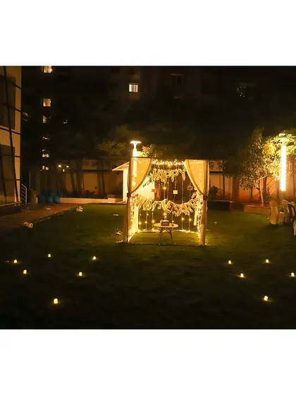 This wide shot shows how we can set up a romantic cabana in a garden or lawn, creating a private oasis complete with a candlelit path leading to the entrance.