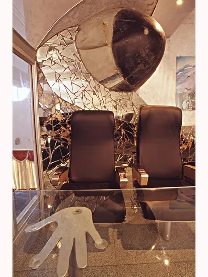 A shattered mirror installation and the nose cone of an aircraft create a dramatic, artistic backdrop in the bar. This is an example of how we use recycled materials to create powerful visual statements.