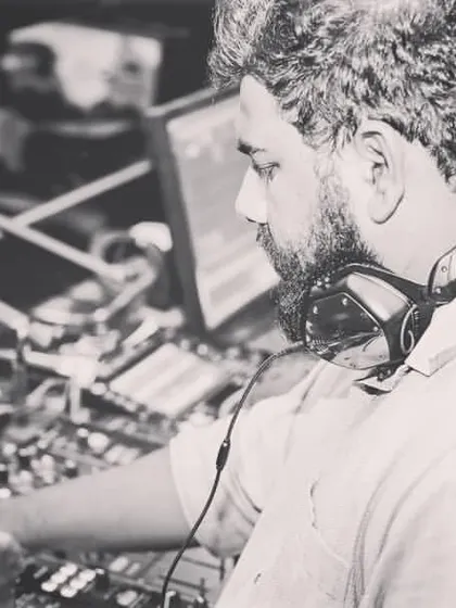 A black and white shot showing the focus it takes to manage the music and the energy of the room.