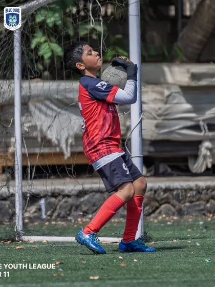 Our U11 goalkeeper confidently collecting the ball during a Thane Youth League match.