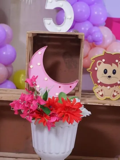 A close-up of some of the cute props used in a butterfly-themed party, including a light-up moon and lion.