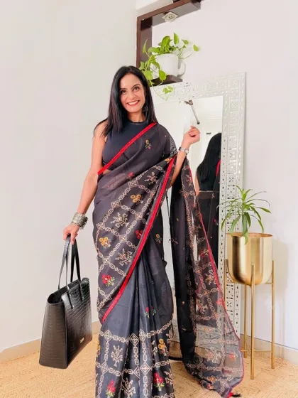 This black saree with a red border and embroidered pallu is a very elegant workwear option from Amazon. It's a sophisticated piece that makes a statement.