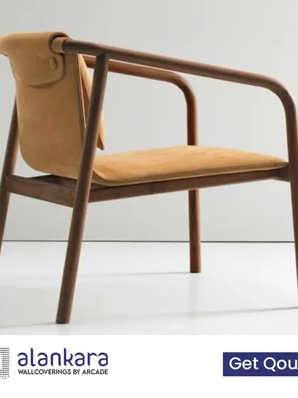 A minimalist wooden chair with a unique, leather-cushioned backrest, designed for both comfort and high style.