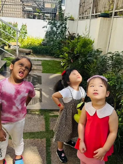 A group of young explorers looks up, fully engaged in our outdoor lesson on light. I encourage them to notice the world around them and ask "why."