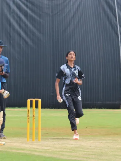 A young bowler running in to deliver the ball during a Dasara Cup match, showing focus and determination.