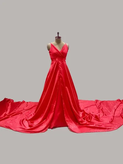 A full view of our vibrant red satin trail gown on a mannequin. This highlights the impressive length of the train and the gown's classic V-neck design, ideal for creating dramatic photoshoot moments.