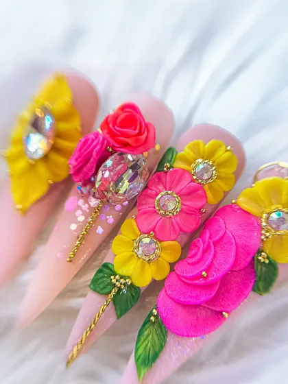 A full view of the hand, showcasing how these elaborate 3D floral designs come together to create a statement manicure.