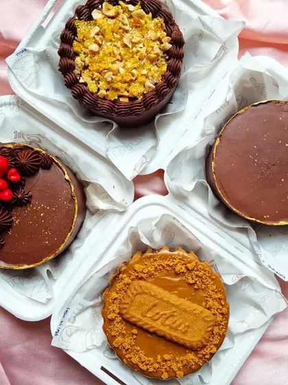 A lineup of some of my most decadent bento cakes. This includes a Lotus Biscoff cheesecake bento, a rich chocolate truffle bento, and a Ferrero Rocher topped one.
