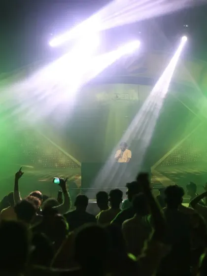 Beams of green light cut through the haze, with the crowd's hands in the air. This is the peak energy moment I build towards in my festival sets.