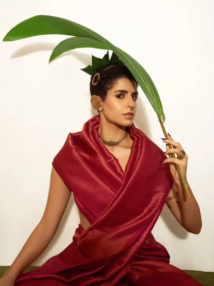 A playful yet strong pose using natural elements. This image shows how we can incorporate simple props to add a dynamic layer to a model's portrait.