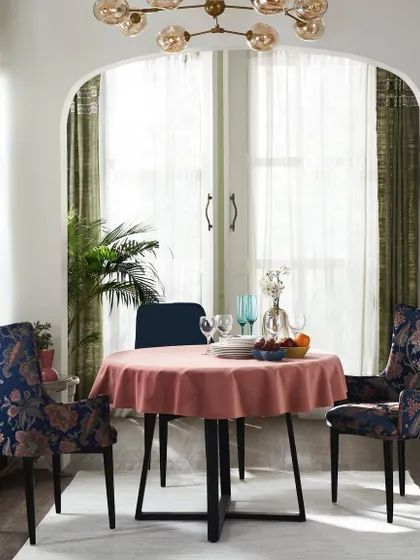 A bright and cheerful dining nook with floral upholstered chairs. The scene is styled to feel fresh and inviting, perfect for showcasing fabric collections for everyday living.