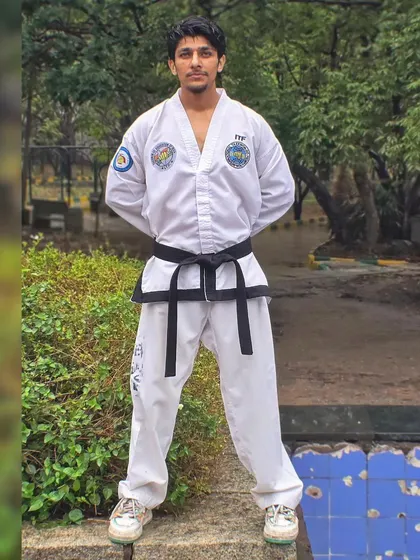I am standing in a formal Taekwondo attention stance, representing the discipline and tradition of the art.