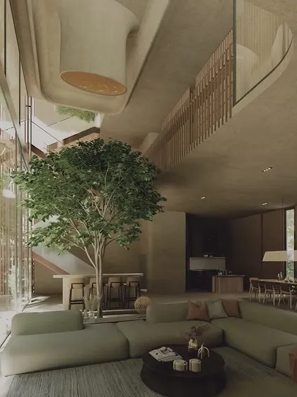 The interior of The Sanctuary, a wellness pavilion in Hyderabad. The design features a large, open-plan living space that flows around a central tree, with soft, curving balconies and earthy materials creating an urban oasis.