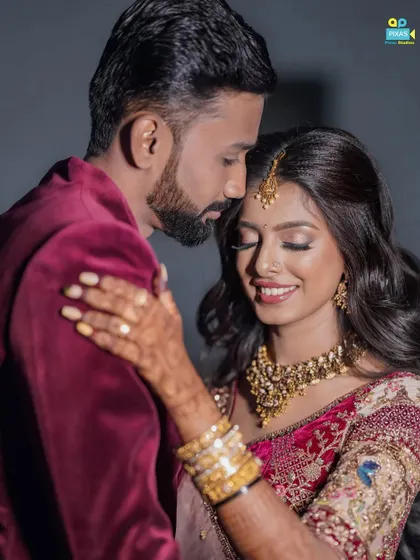 A romantic moment between the happy couple. The makeup is designed to look flawless both in person and in professional photos.