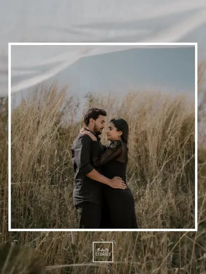An embrace in a wide-open field under a vast sky. This shot creates a sense of epic romance, showing the couple alone together in their own world.