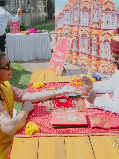 Adding unique activities like a palm reader to a Rajasthani Mela-themed Haldi to entertain guests.