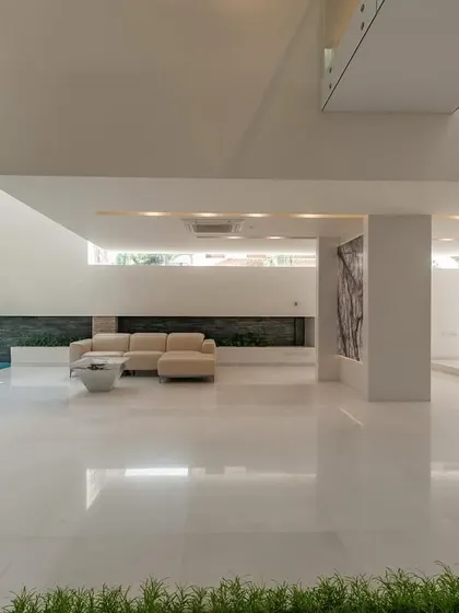 An expansive view of the indoor pool and living space, designed as a single, flowing sanctuary.