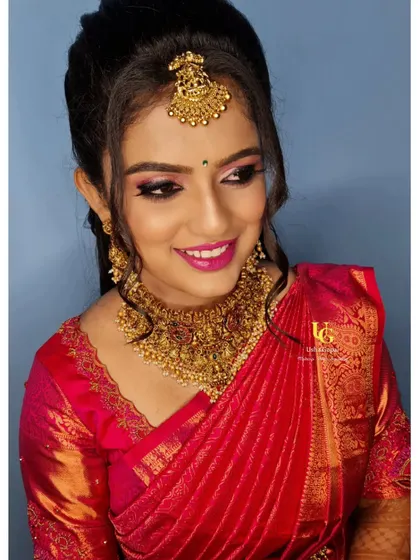 A bright and happy portrait of Geetha, showcasing her complete reception look.