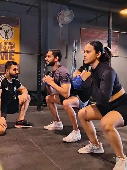 A Monday session sets the tone for the week. Here I am checking the form on a kettlebell goblet squat, ensuring depth and posture are correct. We believe in starting the week strong, together.
