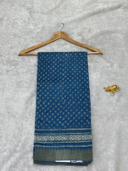A classic blue Bagru printed saree on Chanderi silk. The small, delicate bootis and the simple border make it a perfect choice for elegant daily wear or office wear.